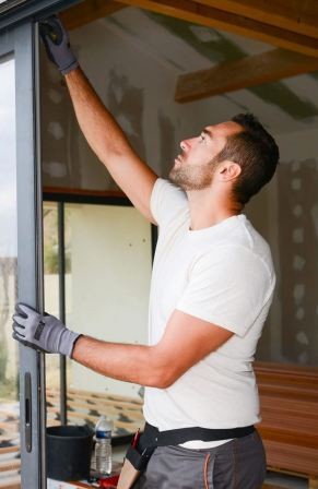 Perfectly aligned sliding glass door showing consistent even gaps and complete weatherstripping compression after professional alignment service