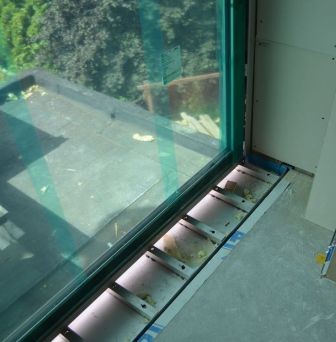 Misaligned sliding door showing daylight and air gaps around weatherstripping indicating energy loss and need for professional alignment adjustment