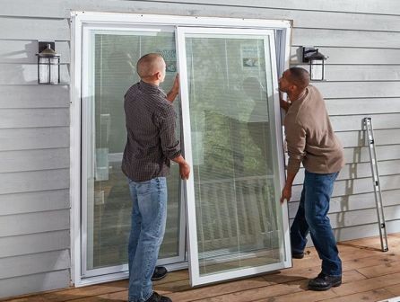 Technician performing final quality check measuring perfect even gaps around properly aligned sliding door after professional adjustment service