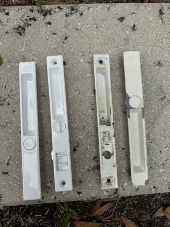 Technician removing old corroded lock mechanism showing internal damage and broken components