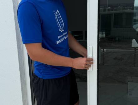 Technician performing anti-lift security test and verifying lock engagement