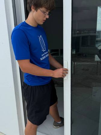 Technician performing security assessment testing lock engagement and anti-lift protection