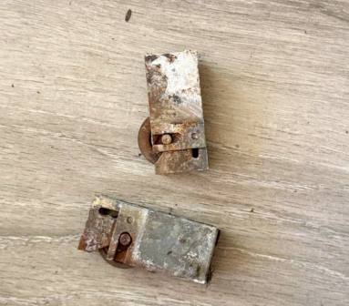 Close-up macro shot of severely worn roller showing flat spots and damage