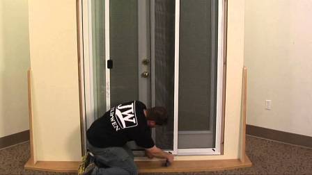 Completed screen door repair showing tight professional mesh installation