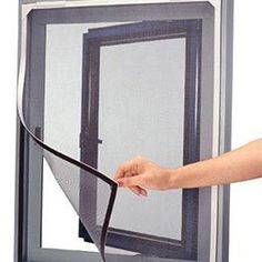 Technician examining screen door damage and measuring frame for mesh replacement